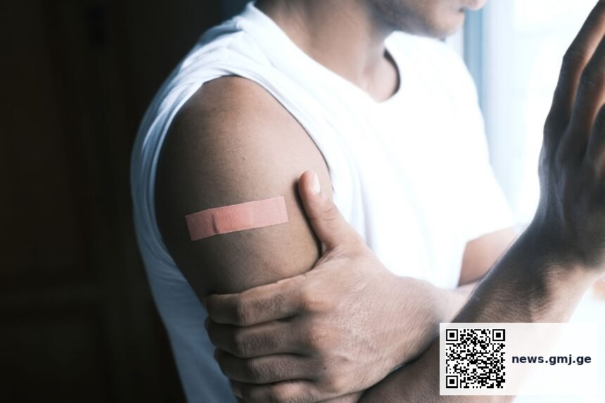 NHS nurse administering RSV vaccine to older adult patient in primary care clinic